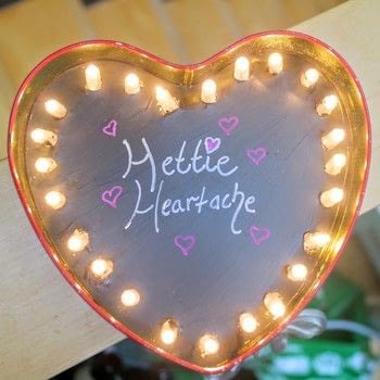 Turn an old chocolate box into a cute marquee light! .  Free tutorial with pictures on how to make a decorative light in under 60 minutes by decorating with chocolate box, chalkboard paint, and paint brush. Inspired by valentine's day and hearts. How To posted by Cat Morley.  in the Home + DIY section Difficulty: Simple. Cost: Cheap. Steps: 8